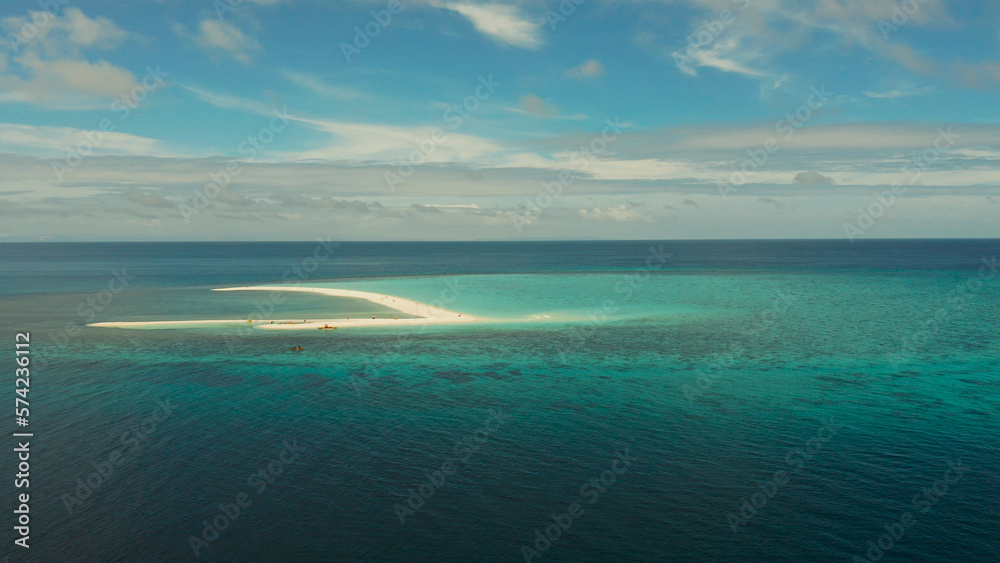 Tropical white island and sandy beach with tourists surrounded by coral reef and blue sea, aerial view. Sandbar Atoll. Island with sand bar and coral reef. Summer and travel vacation concept, Camiguin
