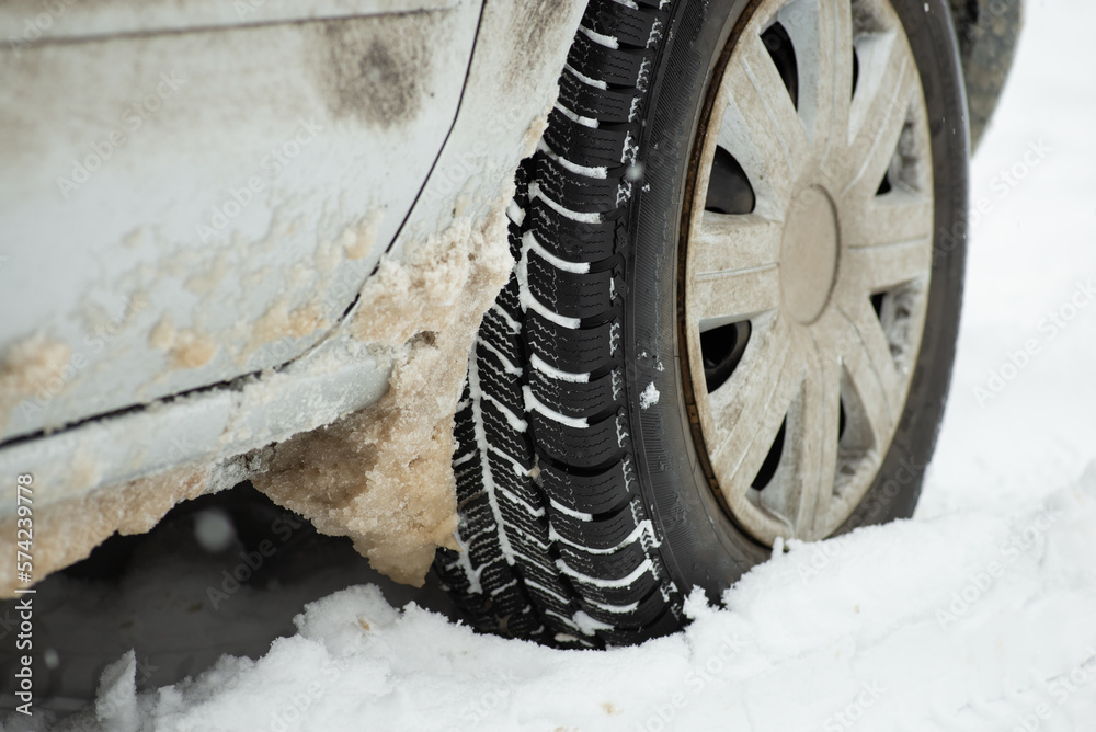 Dirty car in snow from the road. Driving car after heavy blizzard