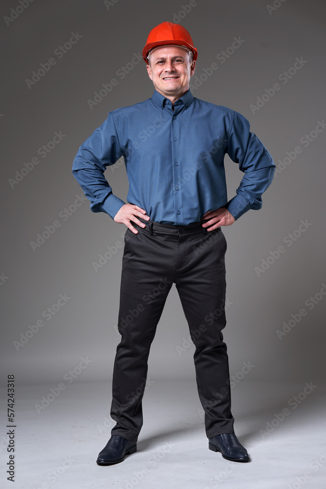 Happy engineer with hands on hips, full length Happy engineer with hands on hips, full length