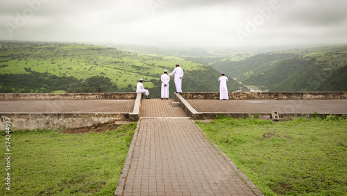 Omani Men Overlooking a vista in Wadi Darbat Park during Khareef photo