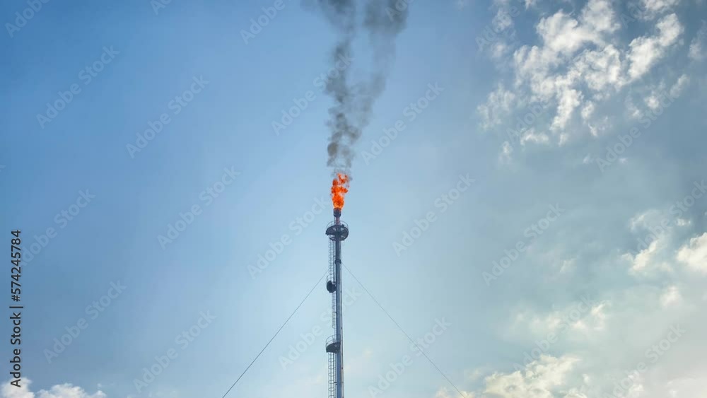 burning gas flare smoking black in Bangladesh on a sunny day with some clouds burning gas flare smoking black in Bangladesh on a sunny day with some clouds