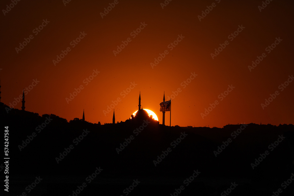 Fatih Mosque and Flag with sun at sunset. Silhoeutte of Istanbul