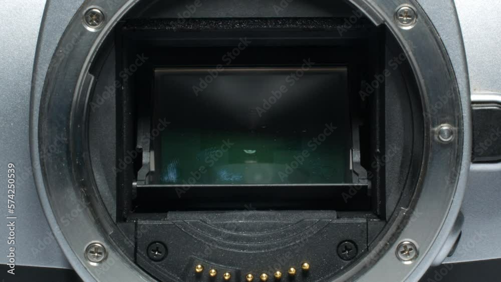 Actuation of the shutter mechanism of an old film camera inside the camera body. Chroma key in the background. Camera shutter release, detailed shooting. Vintage camera shutters.
