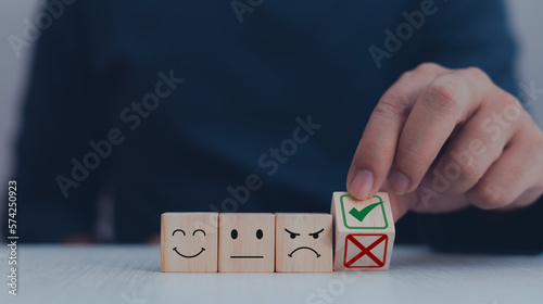 businessman grading satisfaction through wooden blocks