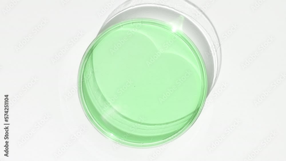 Green eye care gel on watch glass round is covered by the shadow on white background | Eye care gel advertisement Green eye care gel on watch glass round is covered by the shadow on white background | Eye care gel advertisement