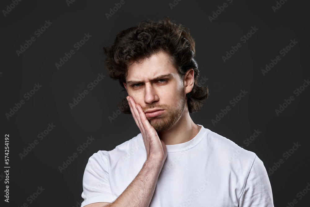 frustrated young man on dark gray background. sadness frustrated young man on dark gray background. sadness