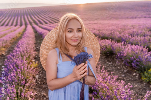 Woman lavender field sunset. Romantic woman walks through the la