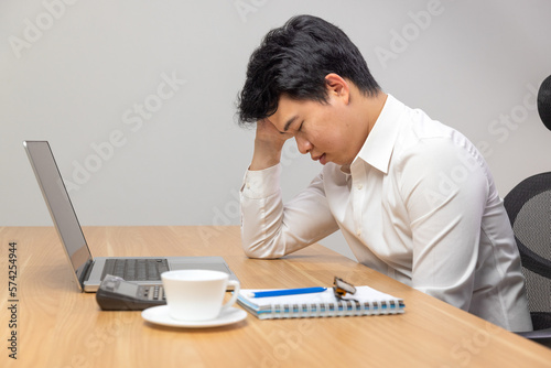 Man with narcolepsy is fall asleep on office desk..Narcolepsy is a sleep disorder that makes people very drowsy during the day. photo