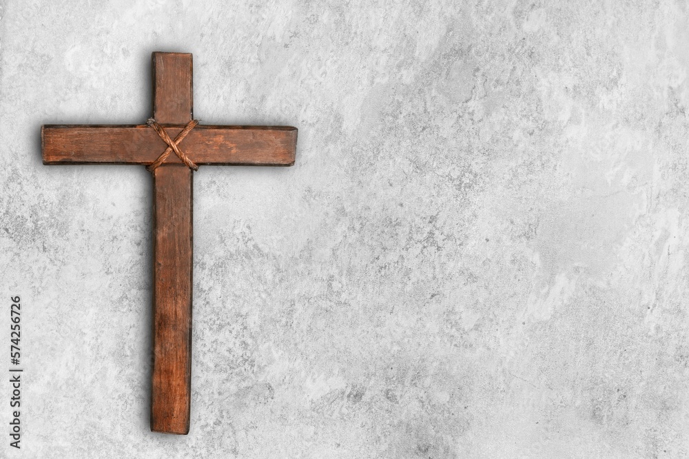 Wooden christian cross on stone desk