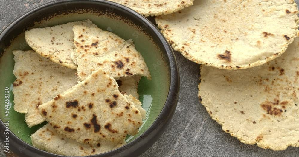 Indian flat corn bread (Makki ki Roti) made of white corn (maize) flour. Table spin. 