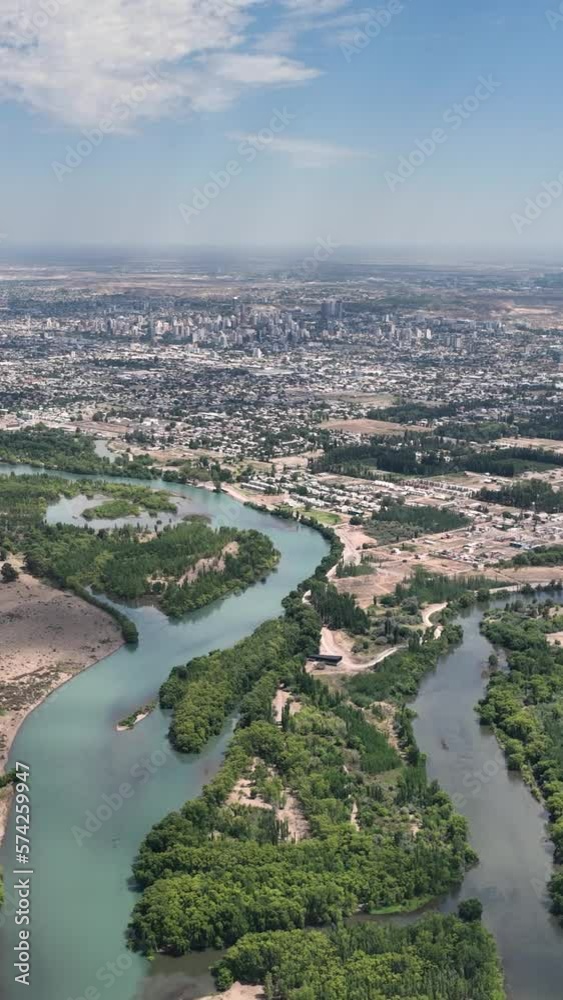 Aerial view of the city of Neuquen. To the left Limay river and to the right Neuquen river. The rivers begin to mix and you can see the different tonalities giving birth to Rio Negro river Aerial view of the city of Neuquen. To the left Limay river and to the right Neuquen river. The rivers begin to mix and you can see the different tonalities giving birth to Rio Negro river