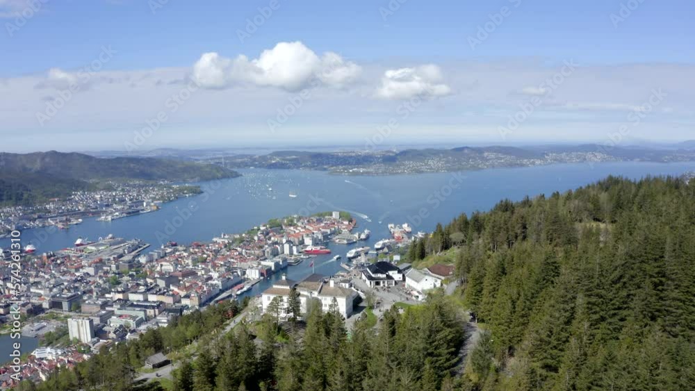 Beautiful drone shot of Bergen, Norway, from above Mount Fløyen. Magnificent view of the city and the restaurant on top of the mountain. Beautiful drone shot of Bergen, Norway, from above Mount Fløyen. Magnificent view of the city and the restaurant on top of the mountain.