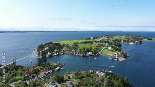 Aerial shot approaching beautiful and idyllic island, Herdla, on the coast of Noerway on a summer day photo