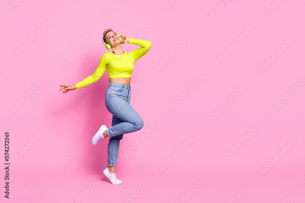 Full body photo of cheerful gorgeous girl stand one leg dancing empty space isolated on pink color background Full body photo of cheerful gorgeous girl stand one leg dancing empty space isolated on pink color background