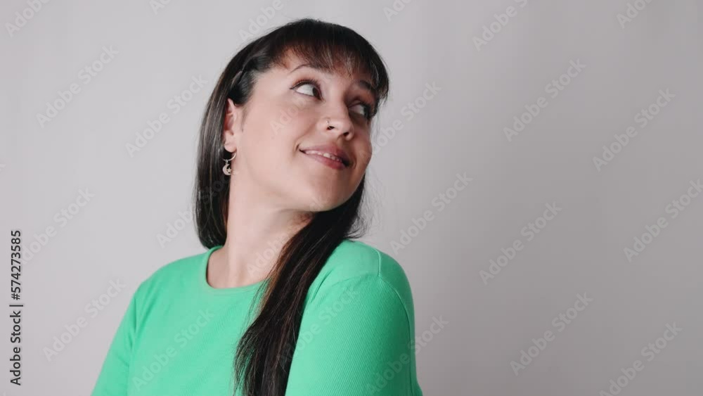 Hispanic real woman looking cheeky away to empty space for advertisement of promotion Hispanic real woman looking cheeky away to empty space for advertisement of promotion