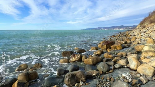 Sea waves on the Black Sea coast. Waves splash on the beach with pebbles in the rays of the sun. Sunset on the Black Sea. Panoramic view of the Black Sea. Kiseleva Rock, Russia, Agoi photo