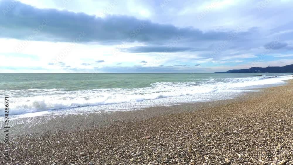 Powerful sea waves are crashing on the Black Sea coast. Waves splash on the beach with pebbles during a storm. Storm at sea. Panoramic view of the Black Sea. Russia. Sunset on the beach. 4K Powerful sea waves are crashing on the Black Sea coast. Waves splash on the beach with pebbles during a storm. Storm at sea. Panoramic view of the Black Sea. Russia. Sunset on the beach. 4K