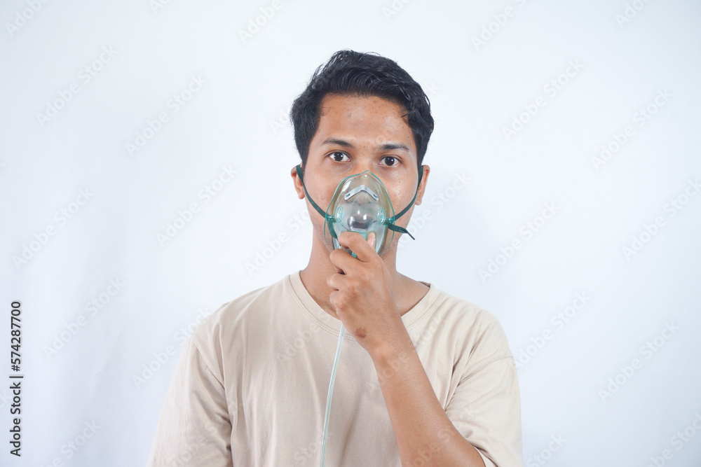unhealthy young man wearing oxygen mask unhealthy young man wearing oxygen mask
