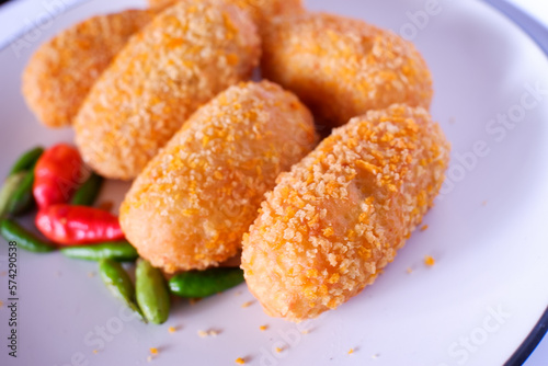 croquettes with cayenne pepper on a white plate