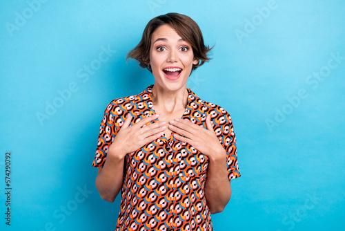 Photo of impressed funny lady dressed print shirt arms chest smiling open mouth isolated blue color background