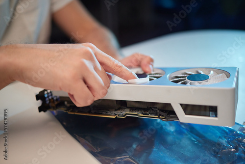 Changing the thermal paste on the graphics processor. Disassembled graphics card on the table. Old graphics card service. photo