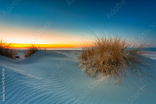 Fototapeta Naklejka Na Ścianę i Meble -  Beautiful scenery of the Baltic Sea beach at sunset, Slowinski National Park, Leba. Poland