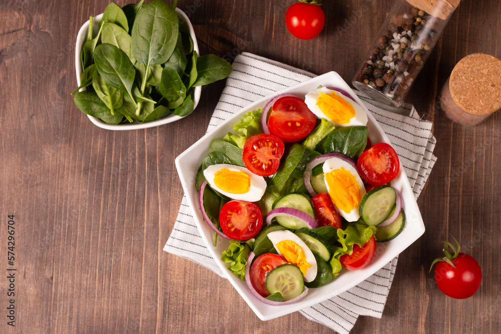 Appetizer healthy salad of fresh tomatoes, cucumber, spinach, lettuce and red onion. Vegan salad. Diet menu. Appetizer healthy salad of fresh tomatoes, cucumber, spinach, lettuce and red onion. Vegan salad. Diet menu.