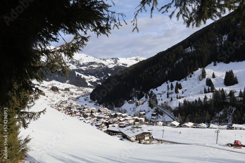 panoramic winter scene of the mountain skiing village Lanersbach stretched out in the valley below photo