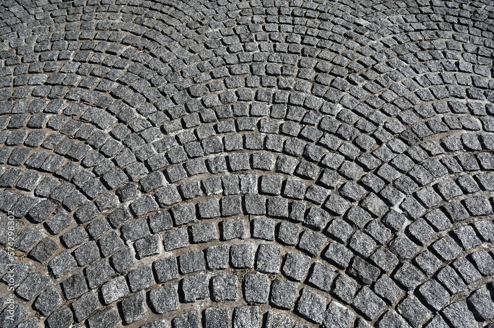 Cobblestone pattern on the road. Cobblestone texture on the street, close up. Brick floor tiles. Cobblestone pattern on the road. Cobblestone texture on the street, close up. Brick floor tiles.