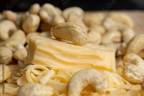 Sliced and grated hard cheese with cashew nuts