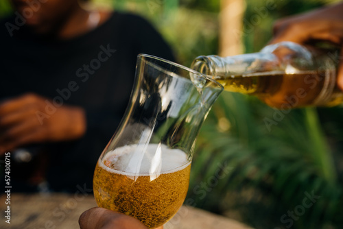 Two queer masculine women having a beer