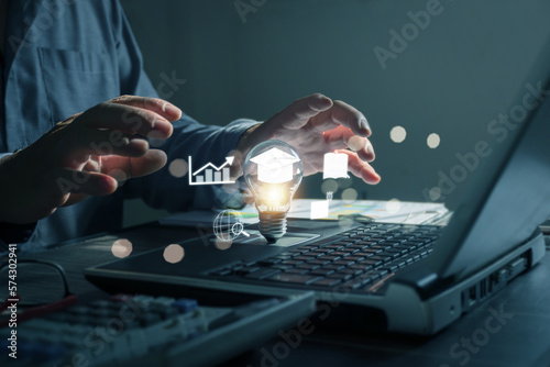 E-Learning Postgraduate Diploma Program Concepts. hand holding light bulb showing graduation cap internet education creative and Study work knowledge and business ai, problem solving, brainstorming.