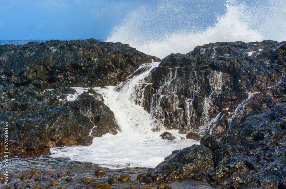 Foamy Water Cascading Over Rocks on Hawaii's Coastline