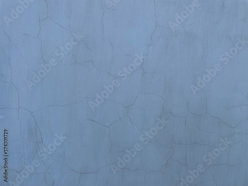 plaster on the blue wall peeled paint as a vintage background