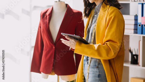 Fashion blogger concept, Young women selling clothes on video streaming.Startup small business SME, using smartphone or tablet taking receive and checking in studio