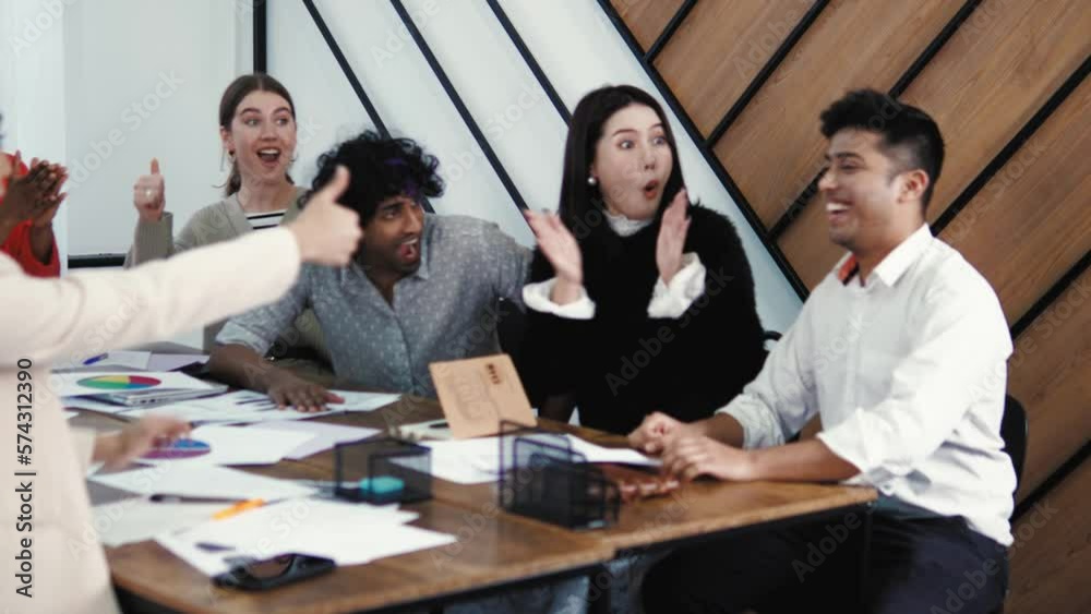 Indian handsome student coming to classroom and sharing good news with his friends classmates. Diverse multiethnic mixed race students greeting and congratulating him with successful work at office Indian handsome student coming to classroom and sharing good news with his friends classmates. Diverse multiethnic mixed race students greeting and congratulating him with successful work at office
