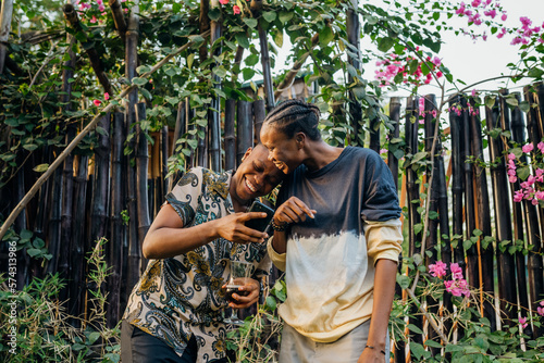 Two queer masculine women talking in a garden