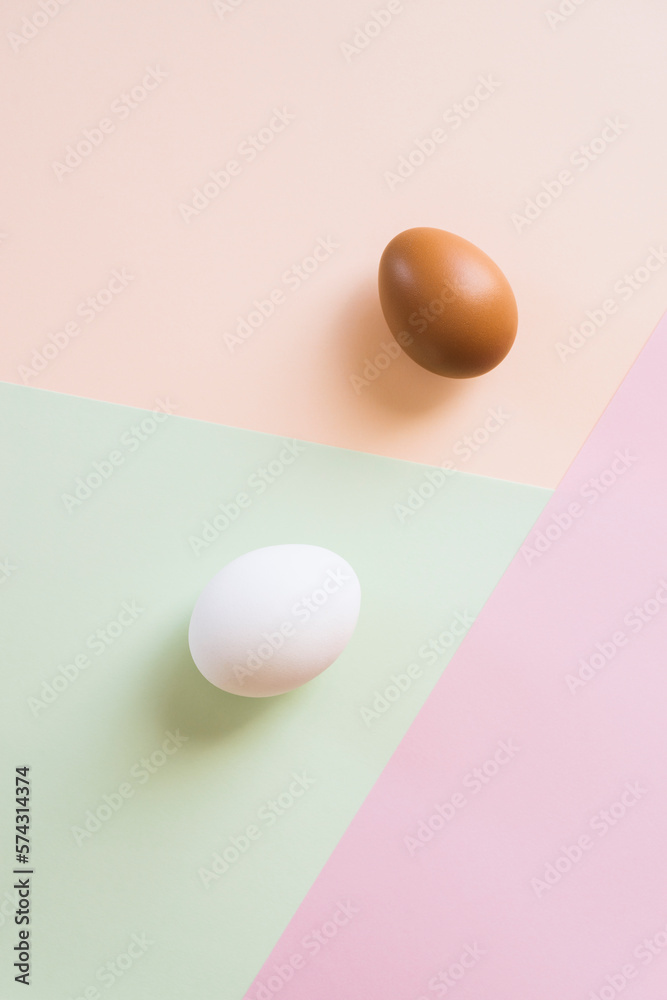 White and brown eggs on multi color background White and brown eggs on multi color background