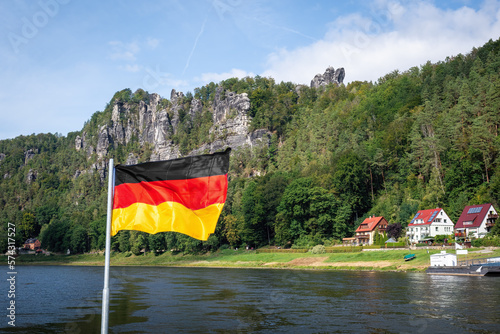 German flag in front of Elbe sandstone mountains at Rathen near Bastei Bridge (Basteibrucke) - Saxony, Germany photo