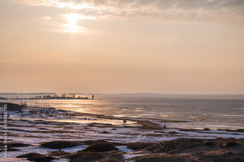 Fototapeta premium sunset over the beach and frozen sea in winter. Kalajoki, Finland