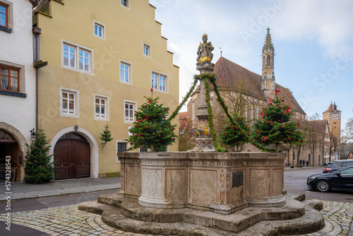 Herrnbrunnen (Nobles Fountain) and Franciscan Church (Franziskanerkirche) at Herrngasse (Nobles Lane Street) - Rothenburg ob der Tauber, Bavaria, Germany