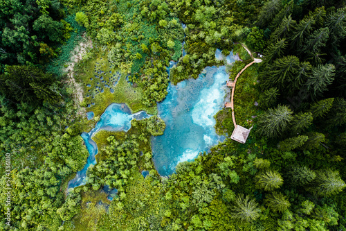 Billede på lærred Aerial view of blue lakes with underground springs in forest area with wooden bo