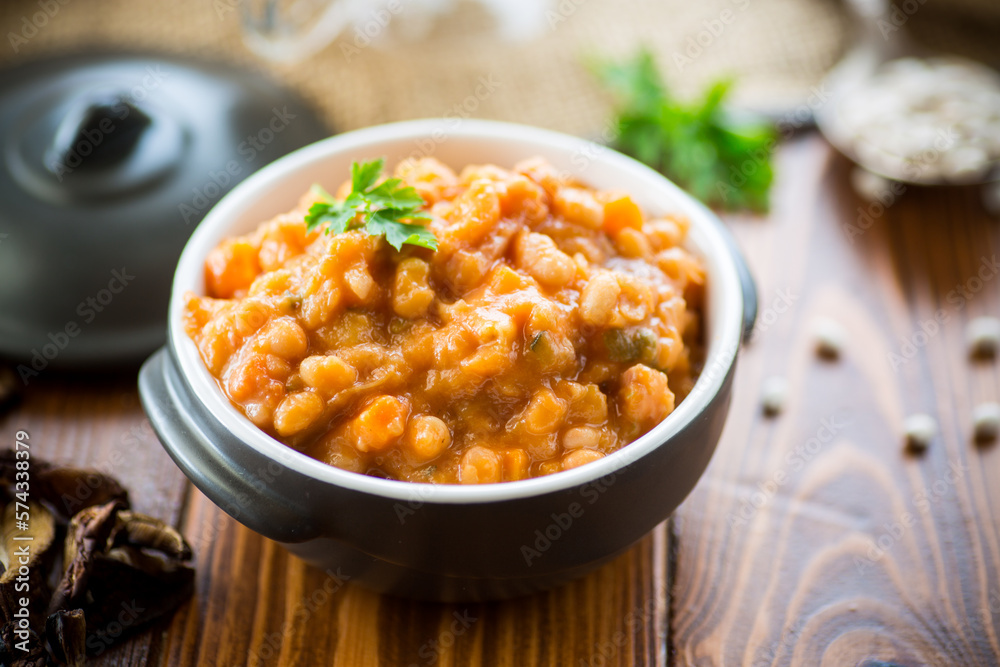 beans stewed with vegetables and spices, in a bowl . beans stewed with vegetables and spices, in a bowl .