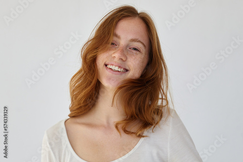 ginger female smiles broadly and feels happy