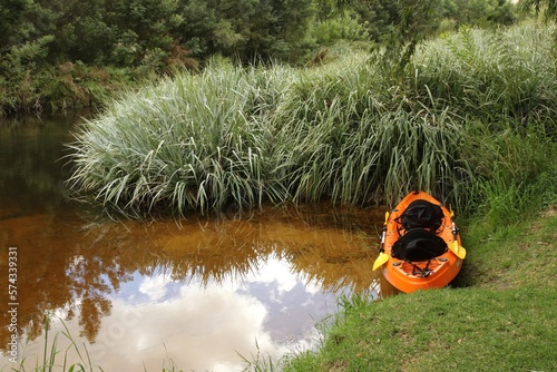 Obraz na płótnie Orange canoe or kayak in calm stream w salonie