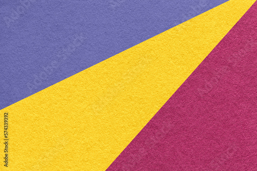 Texture of old craft violet, yellow and purple paper background, macro. Structure of vintage abstract cardboard