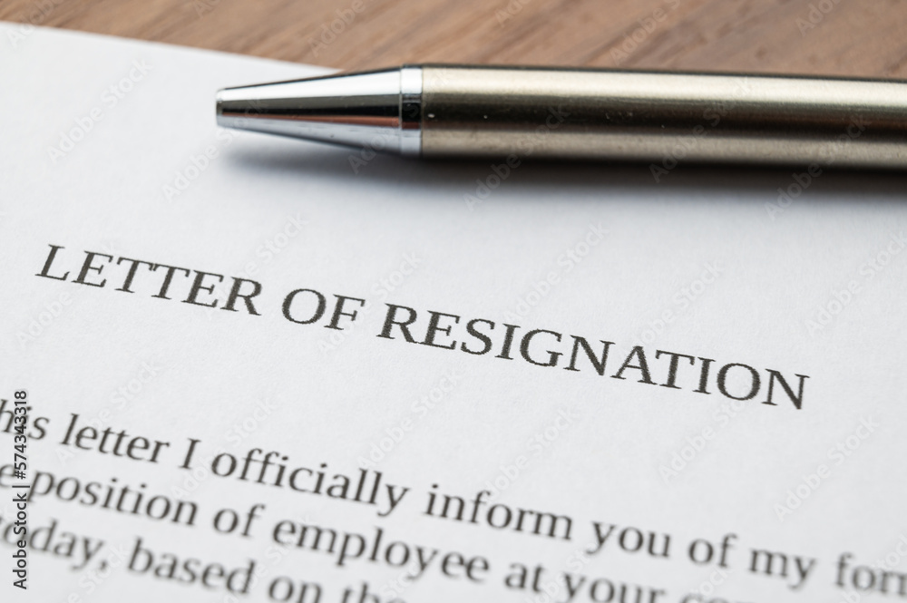 Employee resignation letter and pen beside.
Employee resignation letter and pen beside.