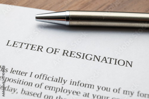 Employee resignation letter and pen beside. 
