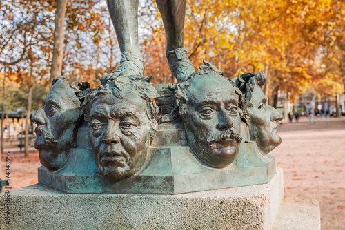 Close up on masks of The Mask Seller statue by Zacharie Astruc in the Luxembourg garden in Paris, France photo