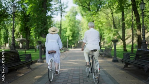 Wallpaper Mural Back view of senior couple riding bicycles, eco-friendly transportation, date Torontodigital.ca